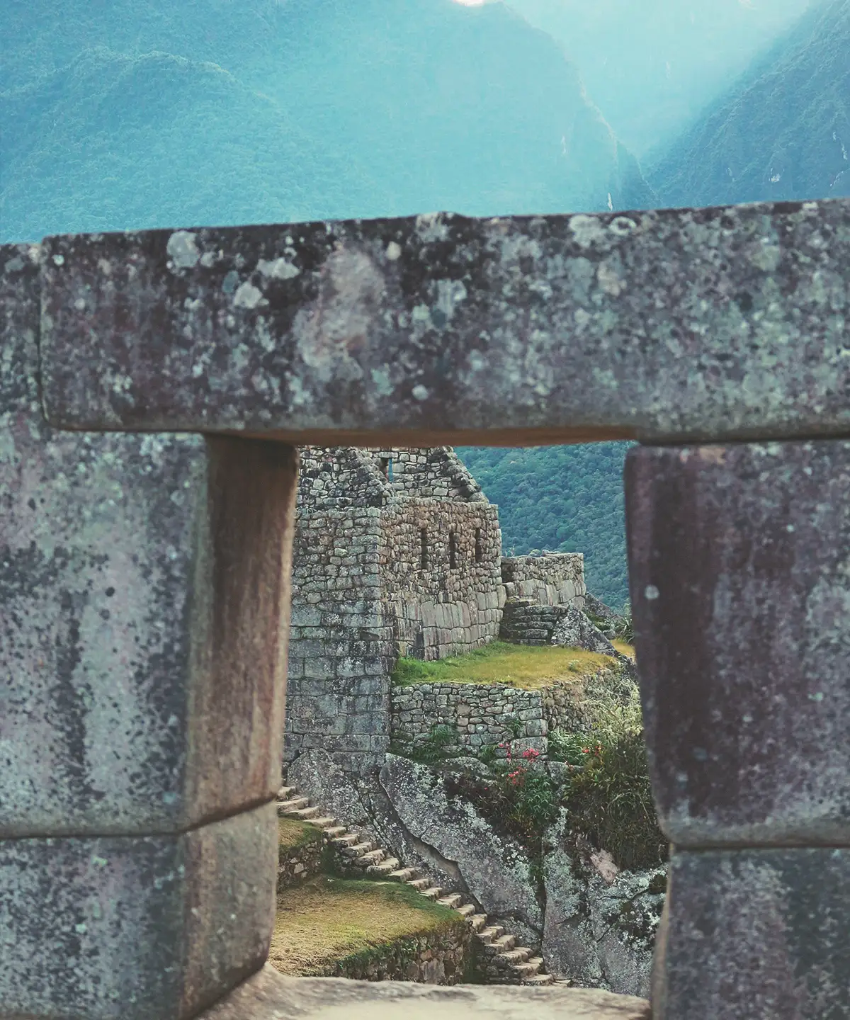 Traveler looking over the Machu Picchu citadel through morning cloud