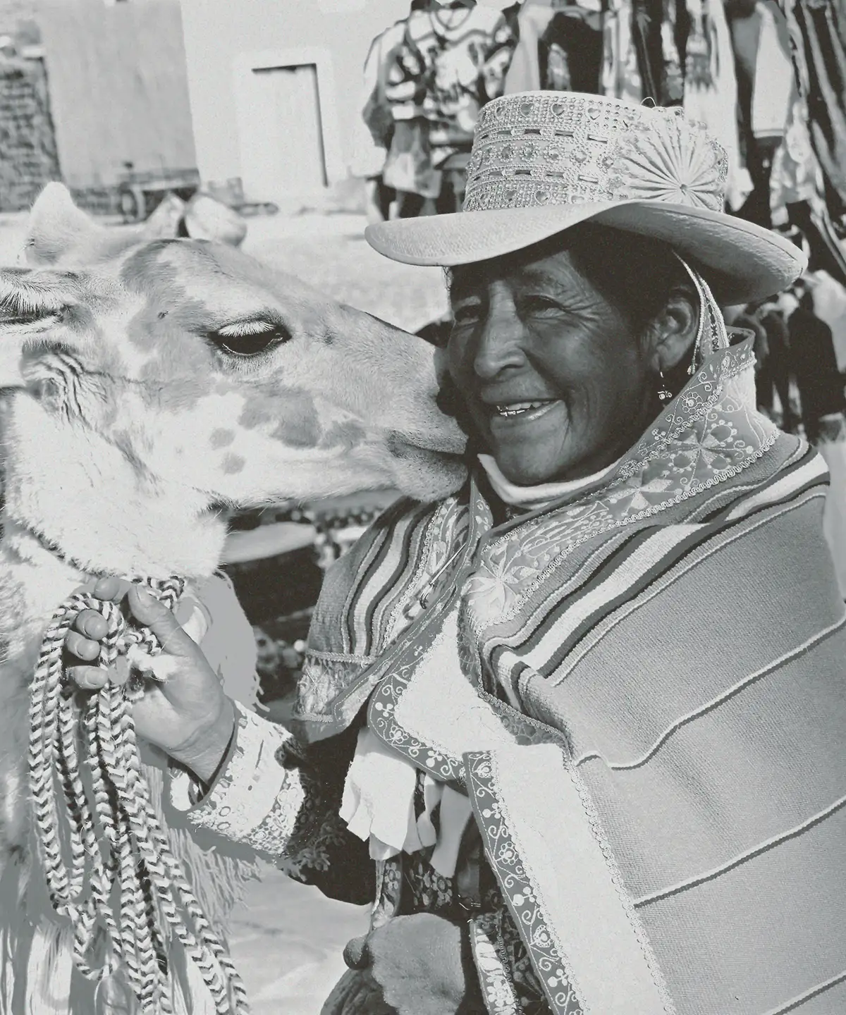Andean woman with her llama at a Cusco market
