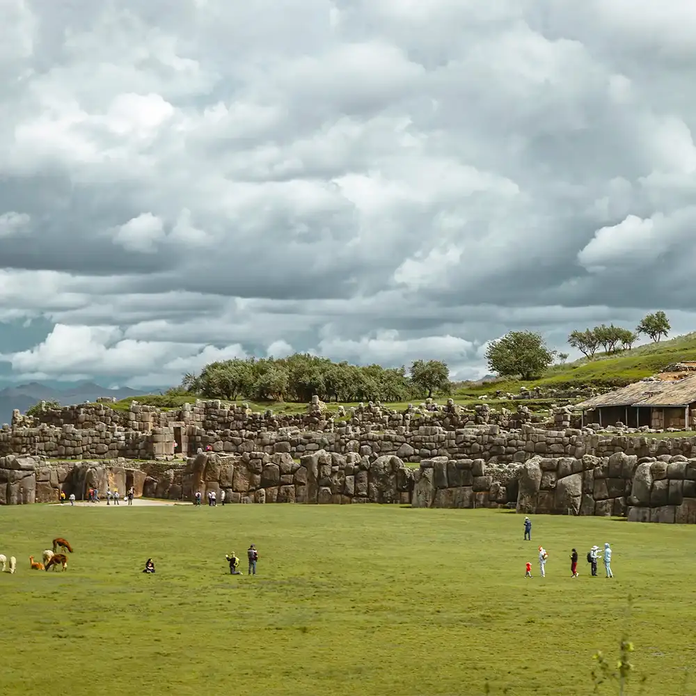 Walls of Sacsayhuamán above a green esplanade