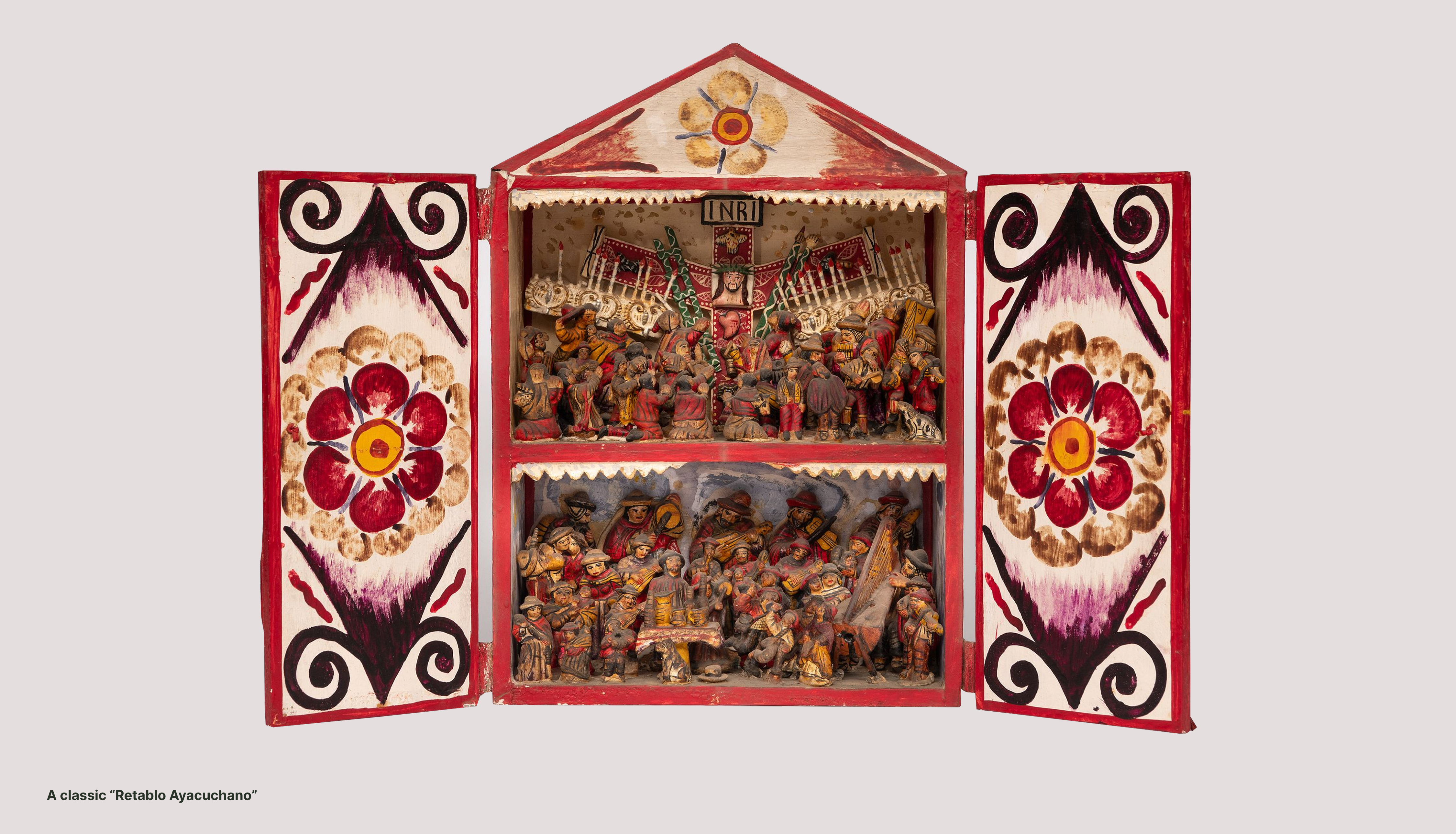 A classic Retablo Ayacuchano: a painted wooden altar box with carved scenes behind its open doors