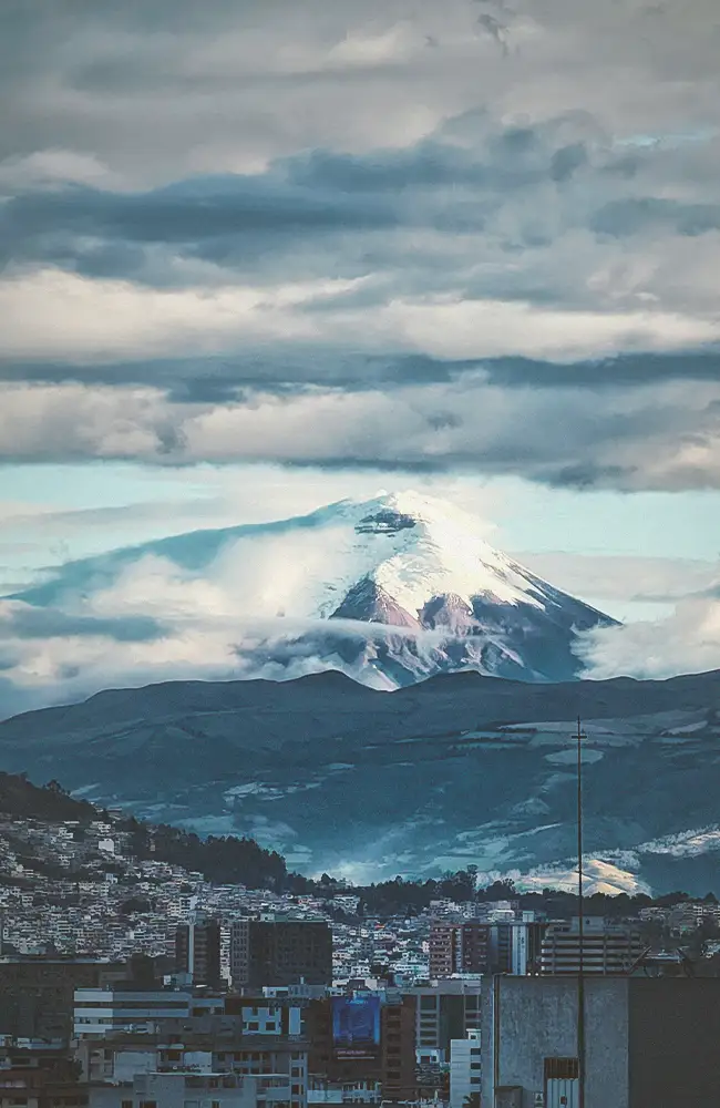 Snow-capped volcano above Quito at sunset